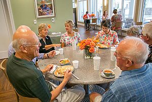Seniors sitting around table talking