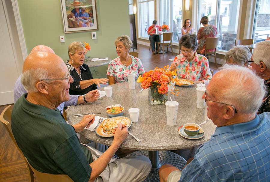 Seniors sitting around table talking