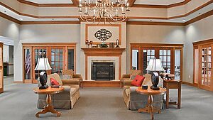 Large room with couches and a fireplace