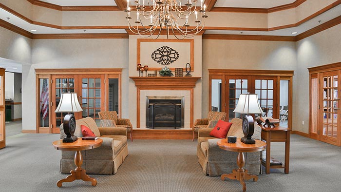 Large room with couches and a fireplace