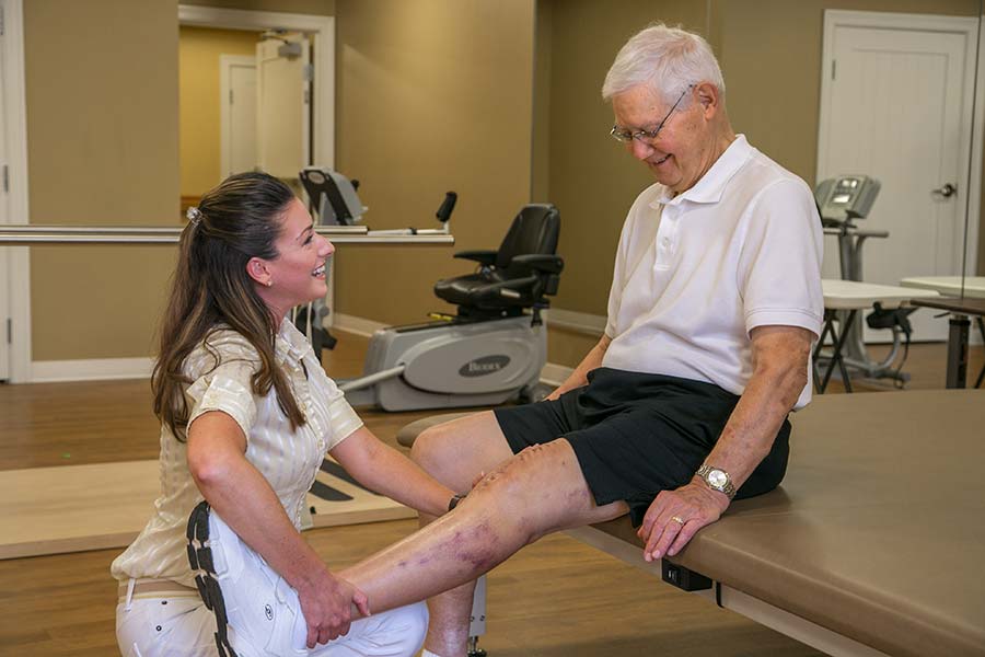 Man stretching with physical therapist