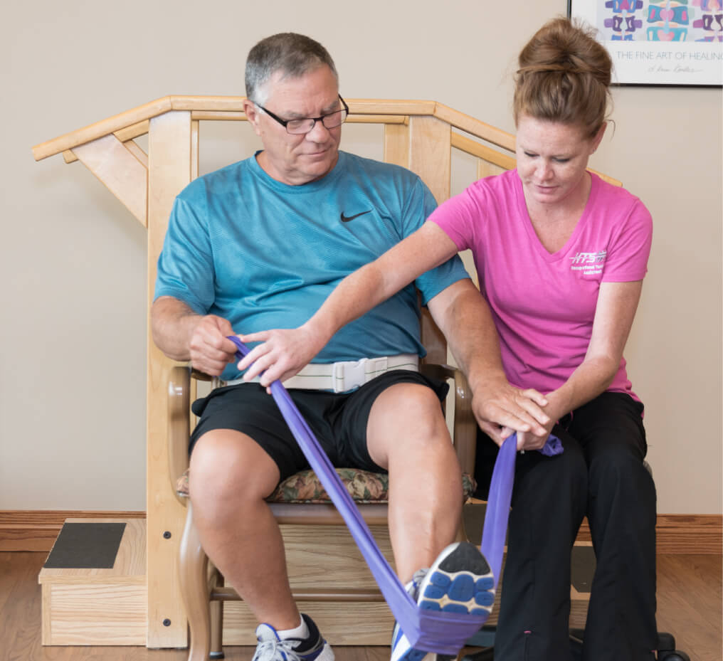 Man doing rehab exercises with instructor