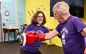 Senior boxing with instructor