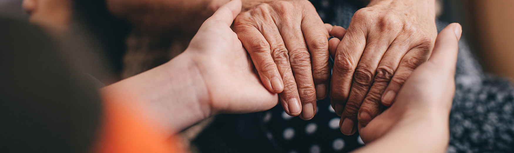 senior hands being held