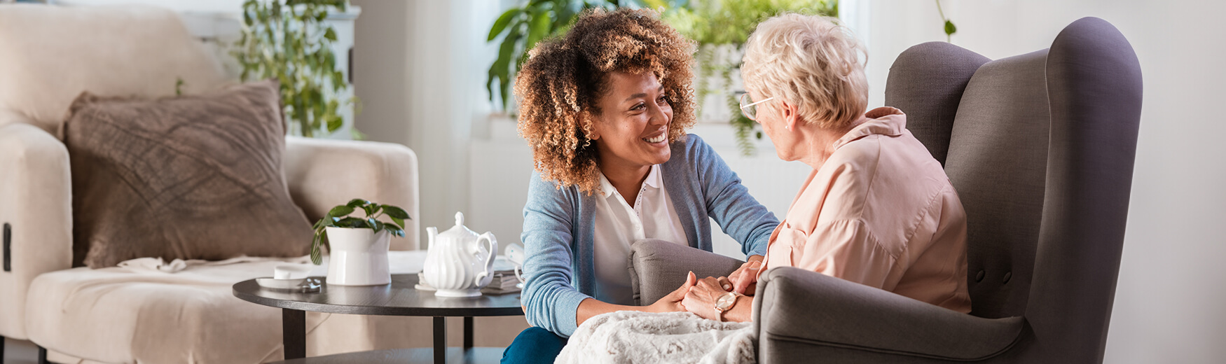 Senior with employee holding hands