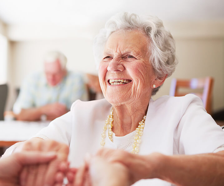 Senior woman holding hands