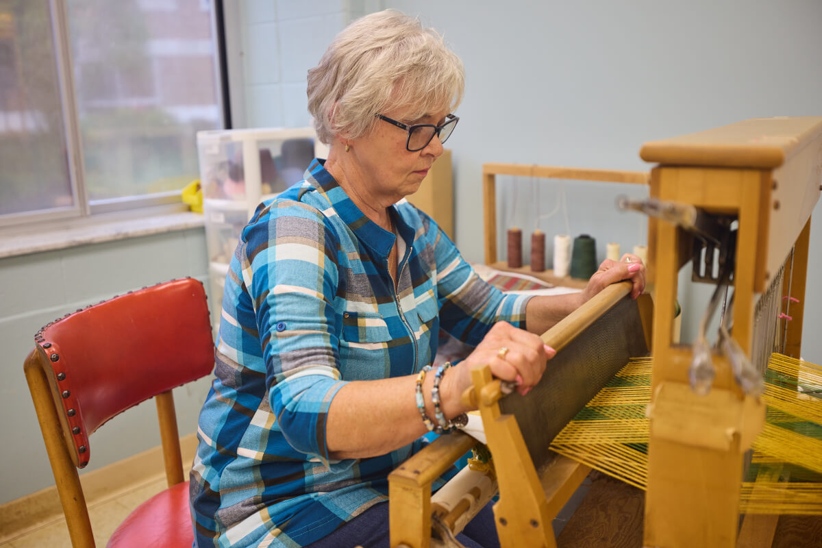 Senior woman practicing weaving