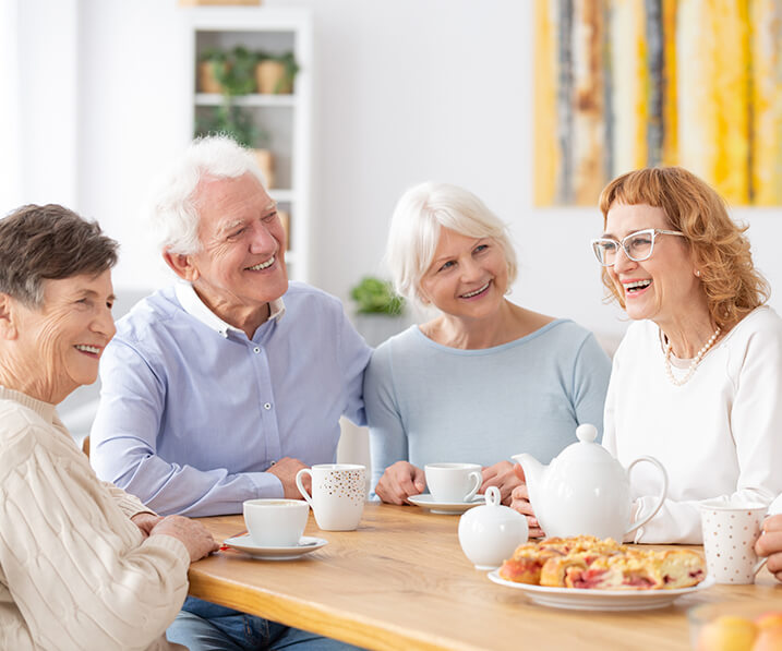 Seniors drinking tea around table