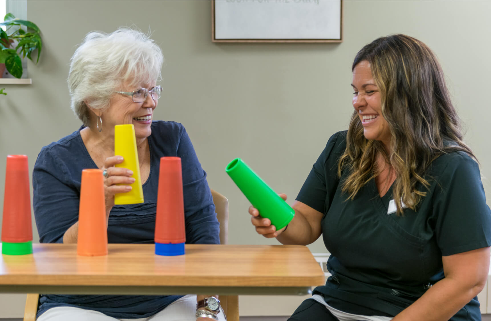 Resident and employee stacking items on the table