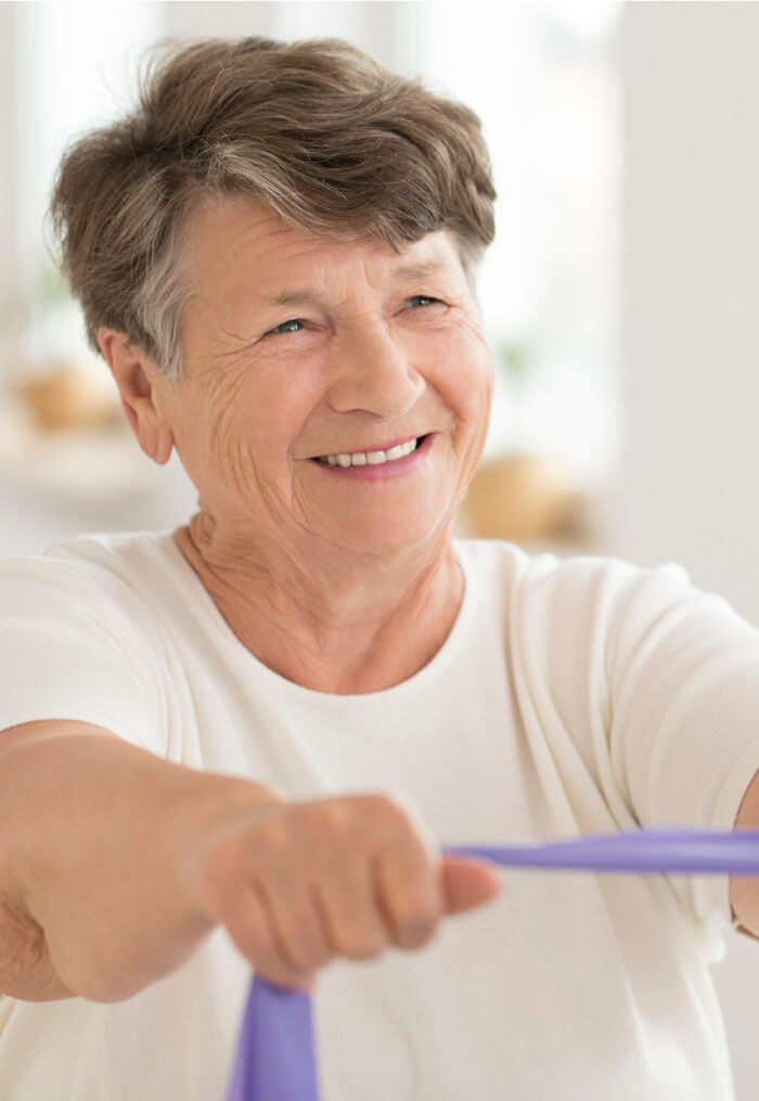 Senior woman using an elastic bands to stretch