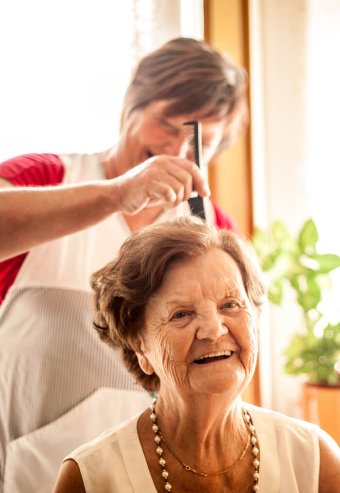 Senior woman getting her hair styled