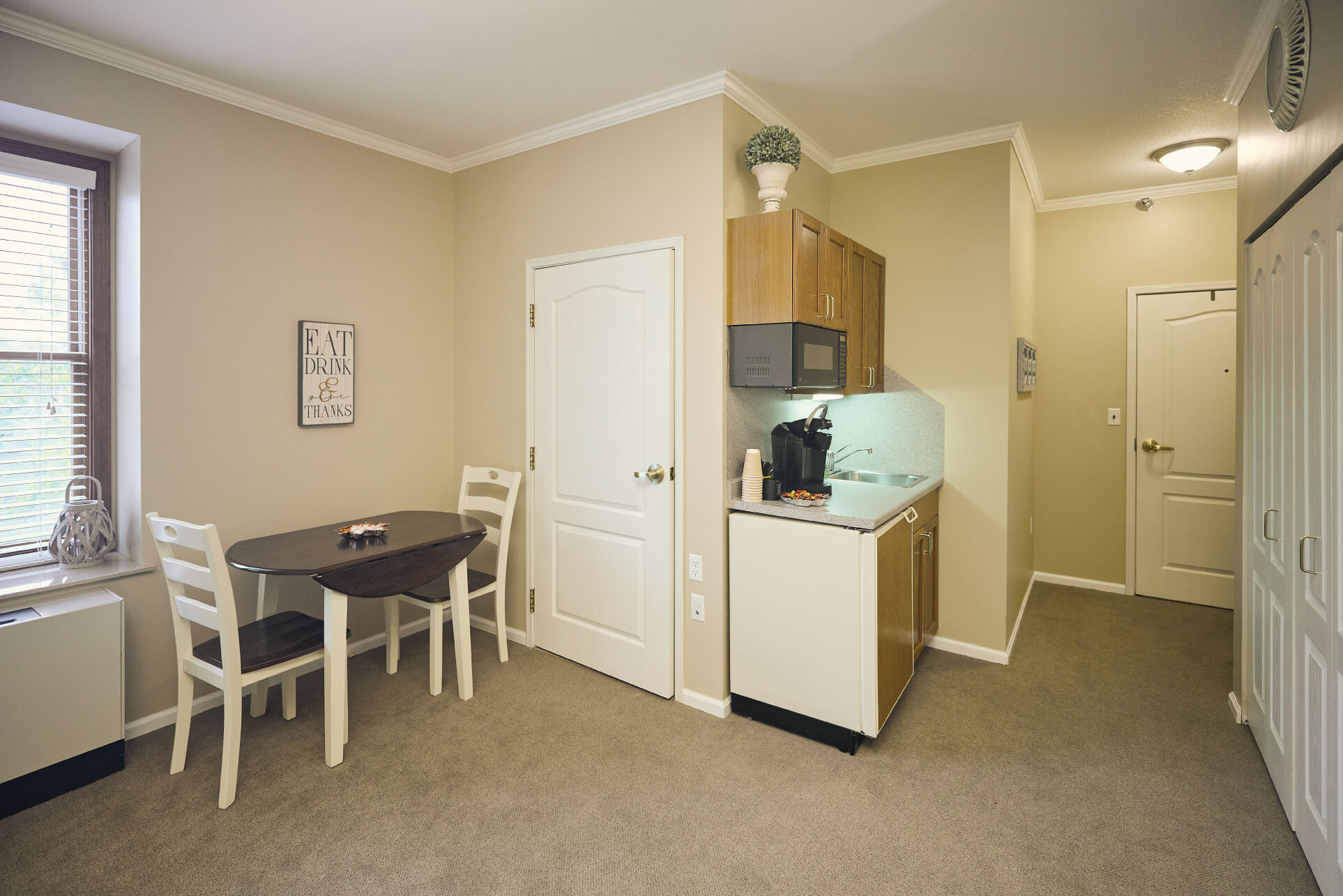 Kitchenette and couple dining table in room