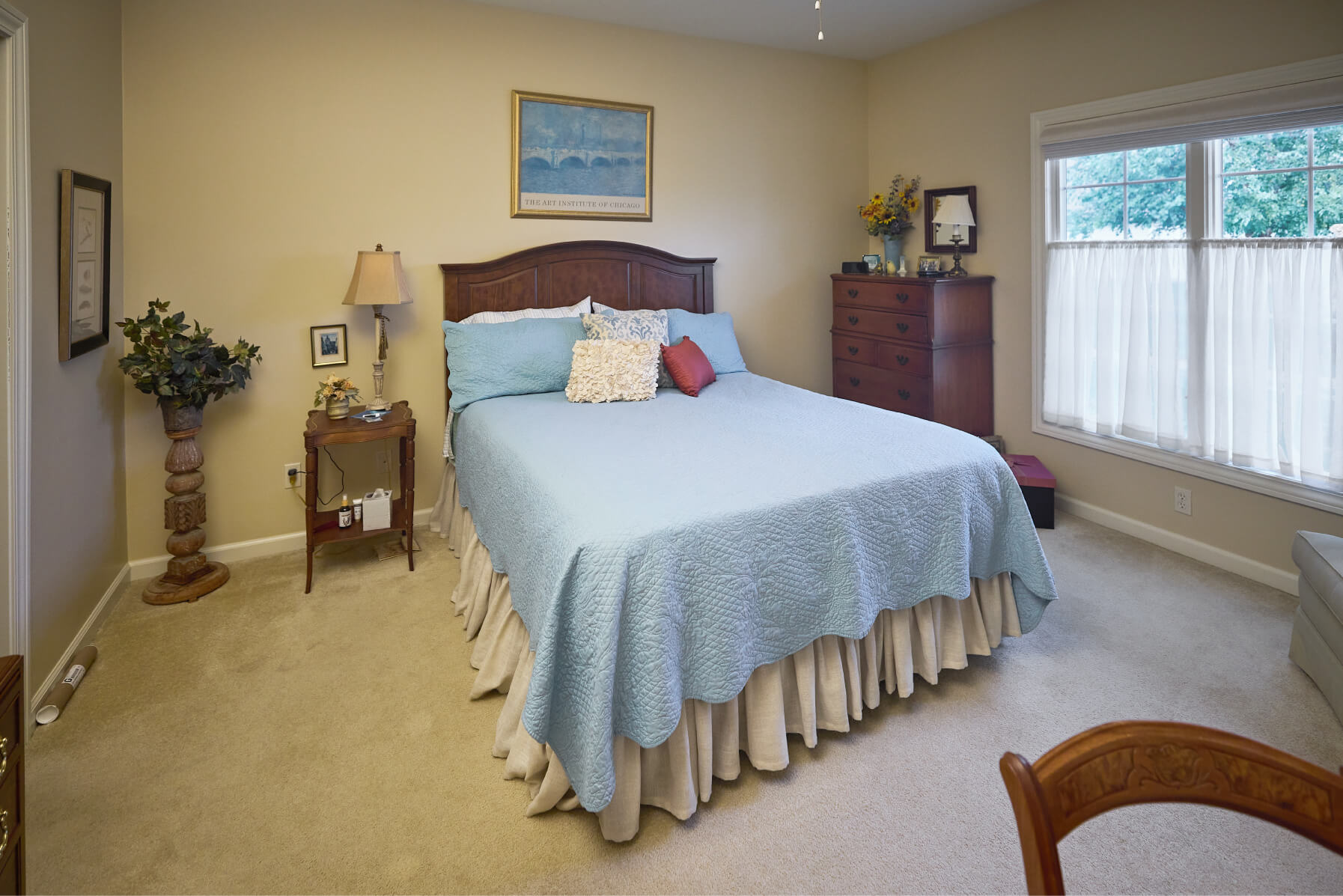 Furnished bedroom with two large windows