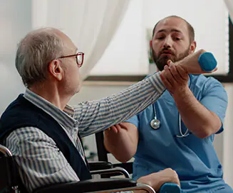 Nurse assisting senior with hand weights