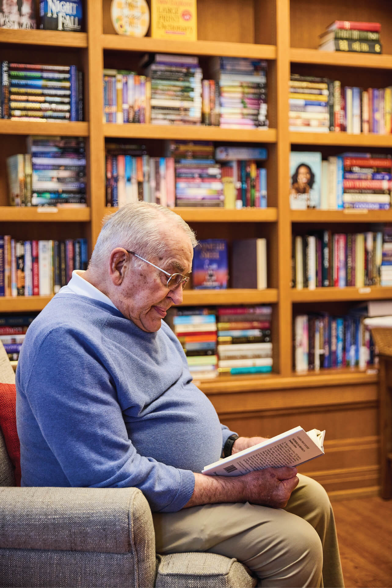 reading-book Man reading in library full of books