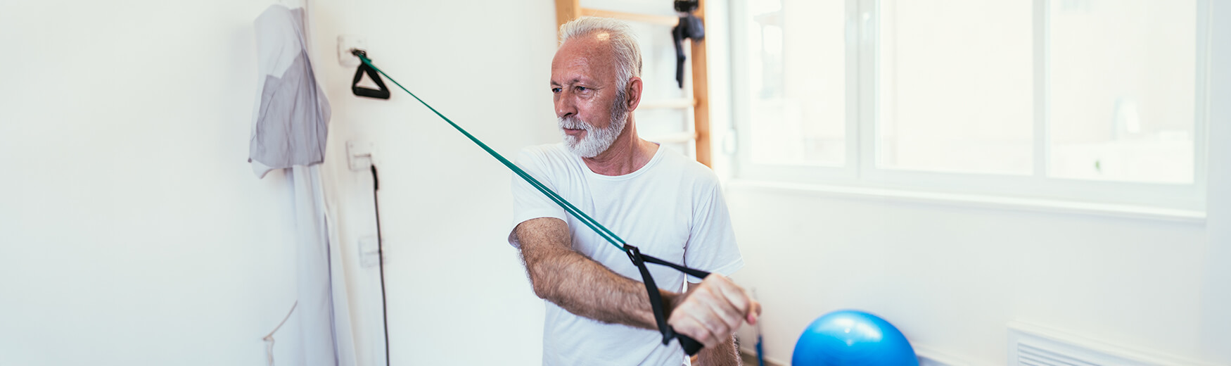 Senior man doing resistance band workout