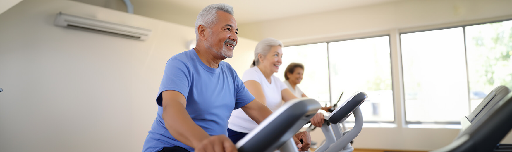 Residents working out at the gym on ellipticals