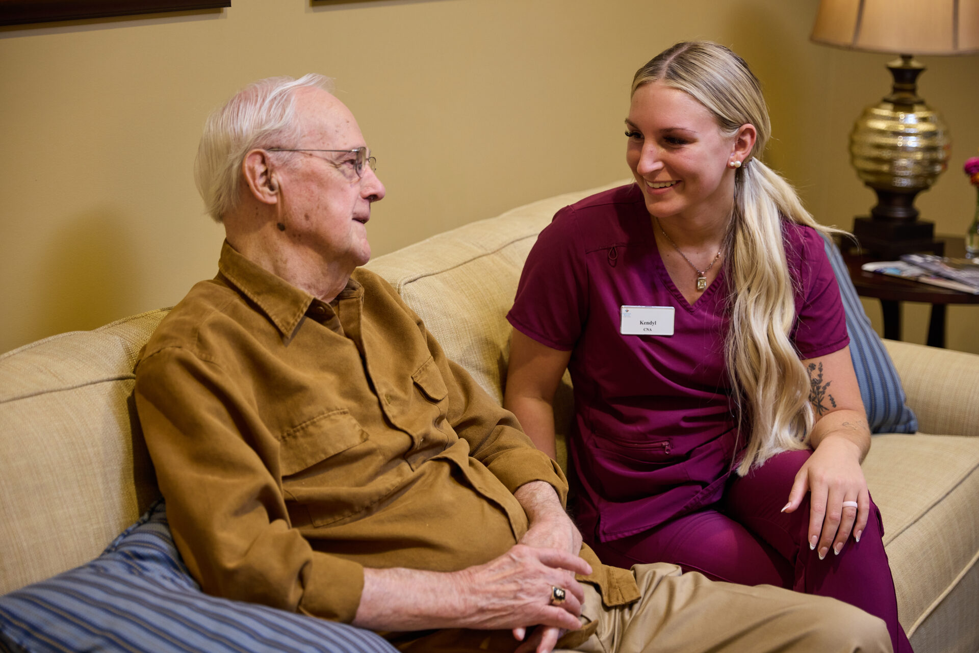 Senior sitting with employee