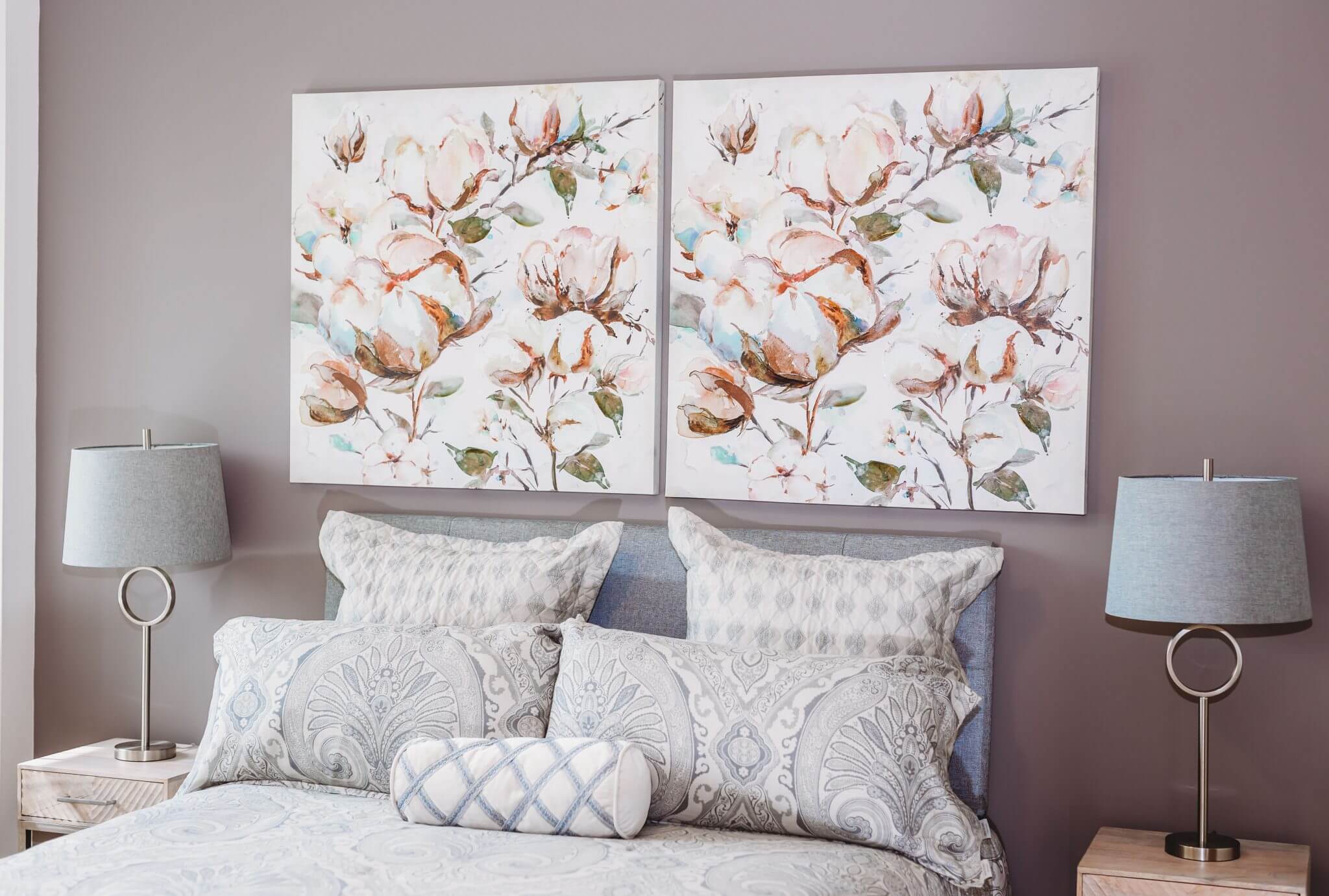 Modern bedroom with floral paintings above the bed