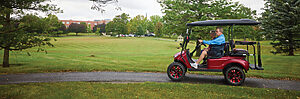 Seniors driving a golf cart through Dogwood Glen