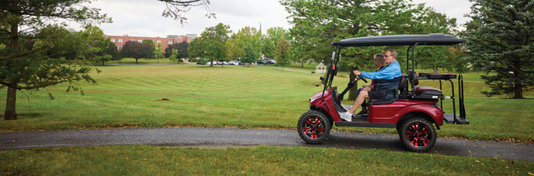 Seniors driving a golf cart through Dogwood Glen