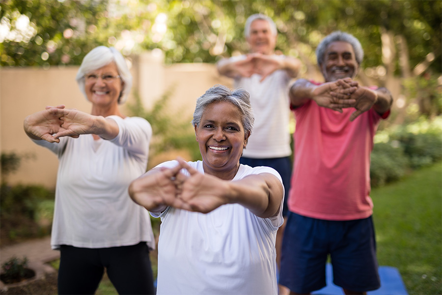 Senior friends stretch outdoors