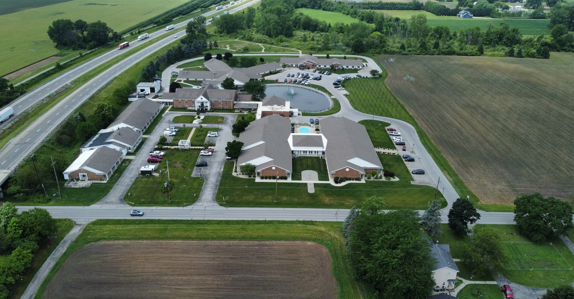 Aerial view of a senior living community with multiple units and landscaped grounds.