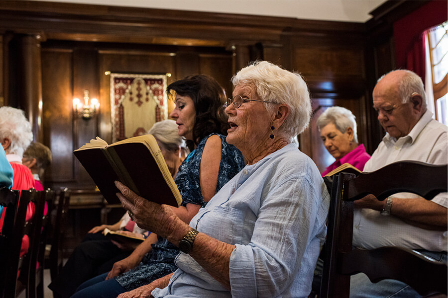Residents of a senior community participating in a group musical activity.