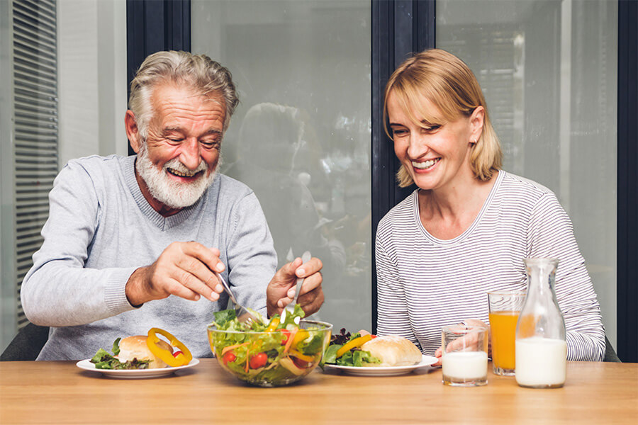 Smiling senior couple enjoying a healthy meal together.