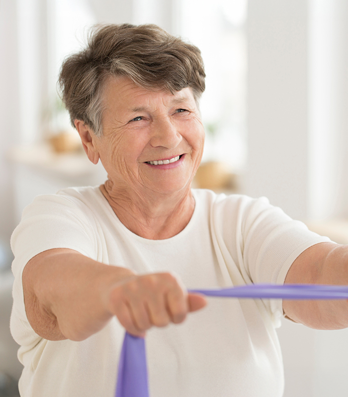 Senior woman using therapy bands
