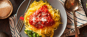 Spagetti squash plated on a dark dining table