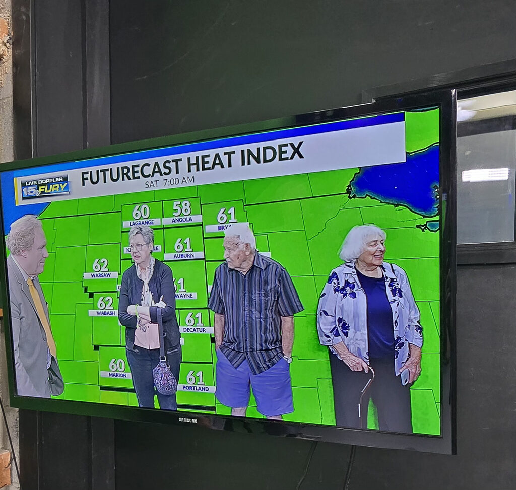 Fort Wayne residents on news broadcast in front of the weather green screen