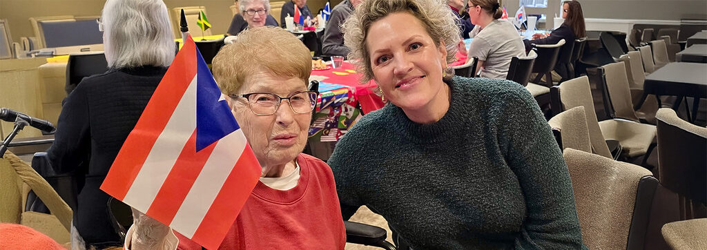Heritage Pointe of Fort Wayne senior waving flag at winter olympics party