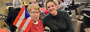 Heritage Pointe of Fort Wayne senior waving flag at winter olympics party