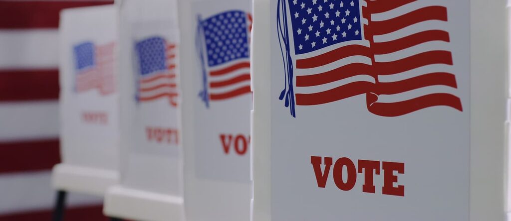 close up of voting booths with American flag image