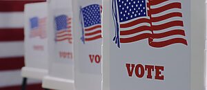 close up of voting booths with American flag image