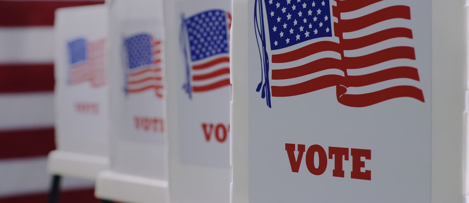 close up of voting booths with American flag image