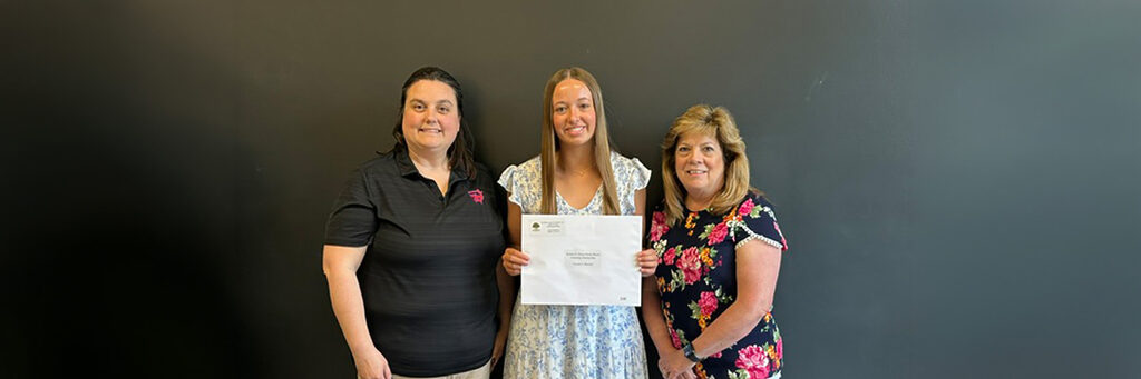 Gracie Reeves and mentors take photo with certificate