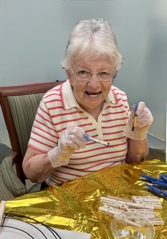 Senior woman smiling as she paints