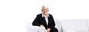 Kim Speidel sitting on white sofa