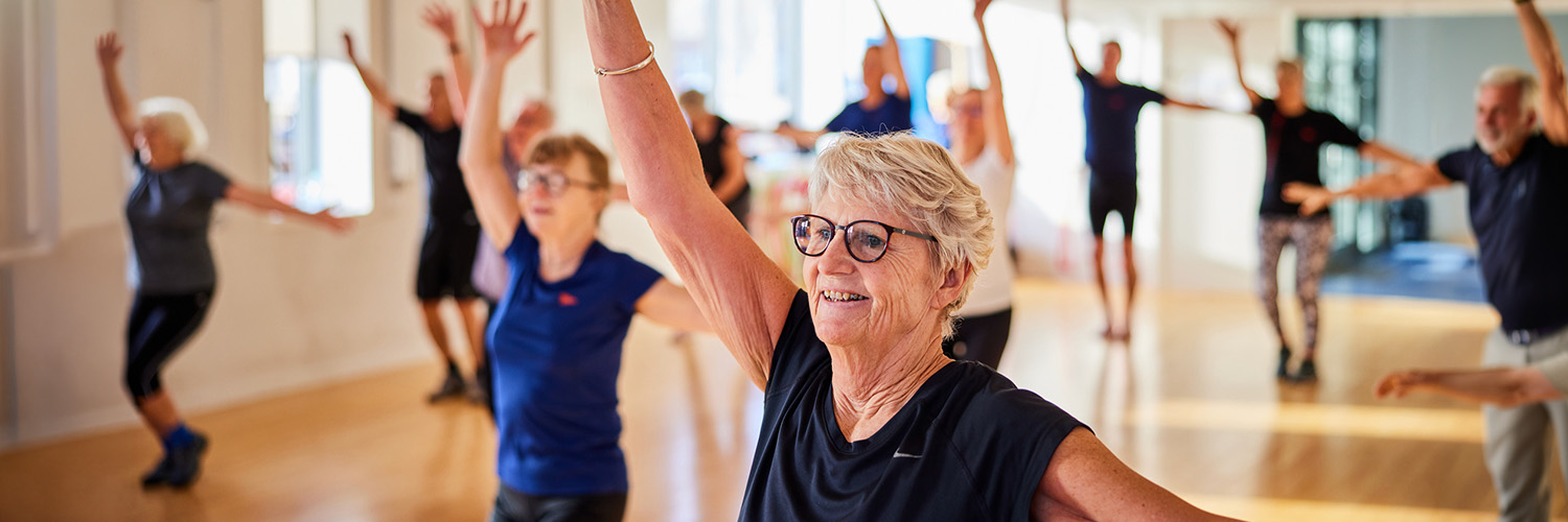 Seniors stretching in a for older adults